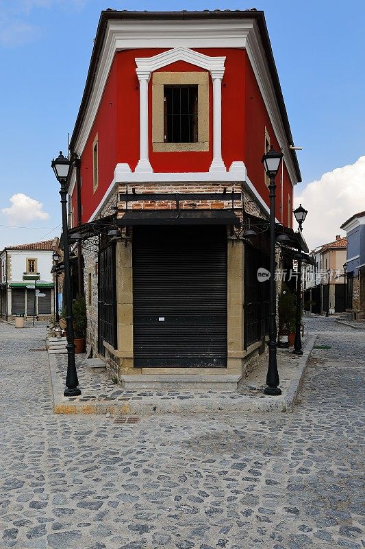 深红色的新古典主义风格的转角砖砌房屋，位于老巴扎地区的ruica petaq Nasi街的鹅卵石上。korca -阿尔巴尼亚- 262